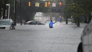 Flooding from heavy rain swamps the intersection of Huger Street and King Street in Charleston, S.C. on Saturday, Oct 3, 2015. The National Weather Service says the risk of flooding will continue through Monday morning, especially in parts of North and South Carolina that already have gotten up to 11 inches of rain this week. Forecasters say some areas could see storm totals as high as 15 inches. (Matthew Fortner/The Post And Courier via AP)